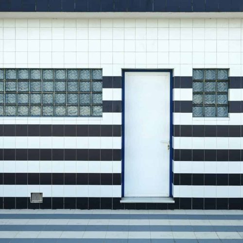 Blue and white tiled facade with glass blocks