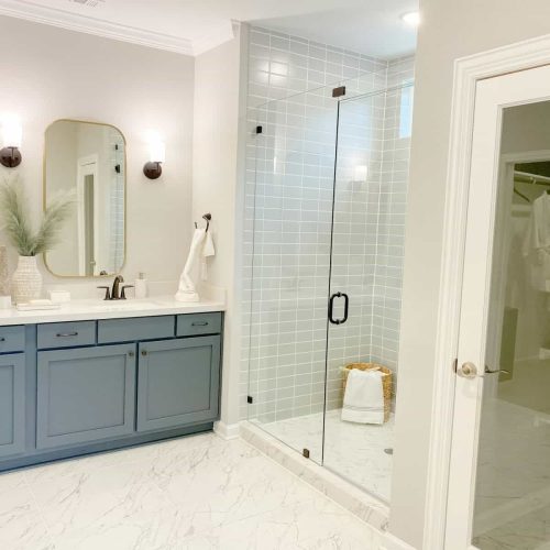 Modern master bathroom with glass and tiled wall in shower